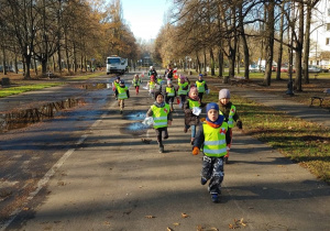 Dzieci biegną przez park do Pomnika Sapera.