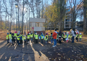 Dzieci są zgromadzone wokół tablicy.