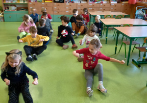 Dzieci ćwiczą pojedynczo na podłodze.